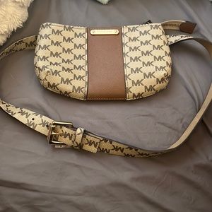A brownish tannish Michael Kors mini belt bag